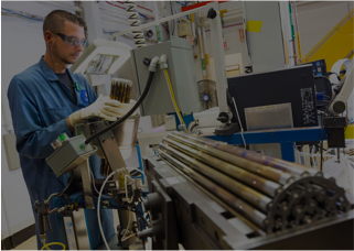 An employee is working on the manufacturing of a fuel cell